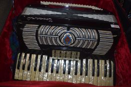 A traditional piano accordion, labelled Toscanti