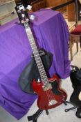 An Epiphone SG Bass guitar with stand and gig bag, with gig bag and stand