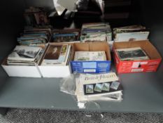 A shelf of vintage and modern Post Cards including black & white, real photo cards, Trains, Street