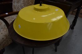 A modern commercial style ceiling light fitting in yellow