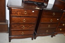 A pair of four drawer stag bedside tables