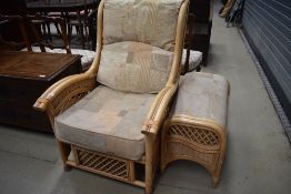 A cane work conservatory chair and footstool
