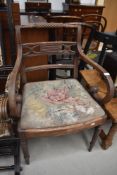 A Regency mahogany scroll armchair having fluted legs(af)