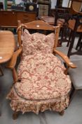 A traditional stained frame and upholstered kitchen armchair