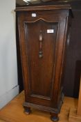 An early 20th Century oak stick stand having turned partitions