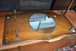 A mid 20th Century oak hall mirror, with coat hooks