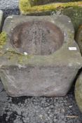 A large stone carved farm house grain mortar or planter