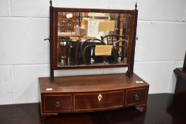 An Edwardian adjustable dressing table mirror having three drawers and inlaid edging