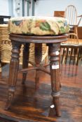 A Regency mahogany revolving piano stool