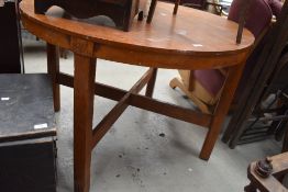 A vintage red stain oak circular dining table