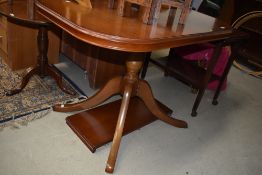 A Rossmore or similar oval dining table