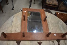 An Arts and Crafts hall mirror/hat rack in the style of Stanley Webb Davies