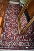 A traditional carpet square in orange and red shades