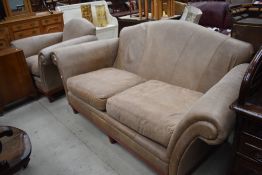 A tan leather settee and armchair