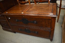 A vintage oak bedding box having lift top, faux top drawer and drawer base
