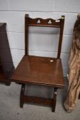 An ecclesiastical style oak hall chair