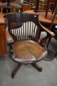 A late 19th or early 20th Century oak captains style revolving office armchair