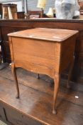 A vintage stained ply sewing table