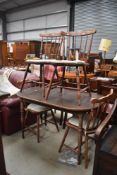 A traditional stained frame kitchen table and set of four spindle back chairs