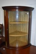 A reproduction bow fronted display having gilt mounts and lining to shelves, of small proportions,