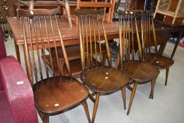 A set of four Ercol dark stained wave and stick back dining chairs