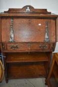 A late Victorian oak bureau with bookshelf under