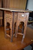 An Anglo Indian style brass inlaid folding table having octagonal top