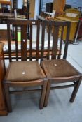 A pair of early to mid 20th Century oak rail back dining chairs