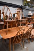 An Ercol dining room table (blue label) and four (three plus one) chairs