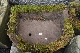 A medium sized hand carved stone water trough or outside sink