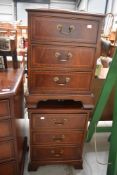 A pair of reproduction Regency style three drawer bedside chests