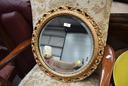 A gilt frame circular wall mirror