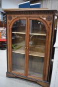 A Victorian Gothic style oak bookcase having inlaid decoration width 106cm height 158cm