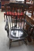 An ebonised rocking chair