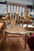 A traditional elm kitchen armchair