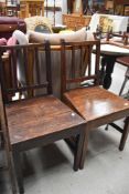 A pair of 19th Century oak solid seat chairs
