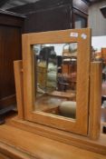 A modern golden oak dressing mirror