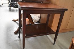 A vintage mahogany fold over tea trolley