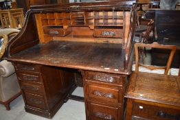 An early to mid 20th Century oak tambour roll top desk
