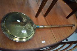 A traditional brass warming pan