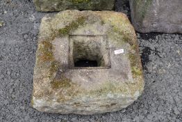 A carved stone water or similar drain cover