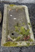 A traditional farm house or cottage style shallow carved stone sink