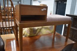 A vintage teak telephone seat