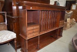 A Victorian mahogany dresser back or shop fitting with segmented centre section, drawers to sides