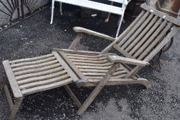 A teak garden lounger or reclining chair
