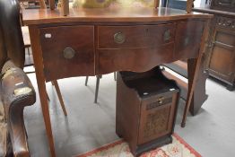 An early 20th Century Regency revival mahogany serpentine fronted sideboard on square tapered legs