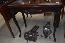 A Victorian style fold over card table having carved applique decoration