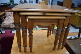 A modern pine nest of three tables