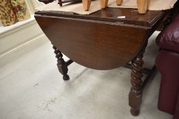 An early 20th Century drop leaf table having twist frame