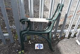A pair of cast iron and wooden handle bench ends